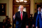 U.S. Senate Majority Leader Mitch McConnell gave a thumbs-up on Wednesday as he left the Senate chamber, where a deal had been reached on a $2 trillio
