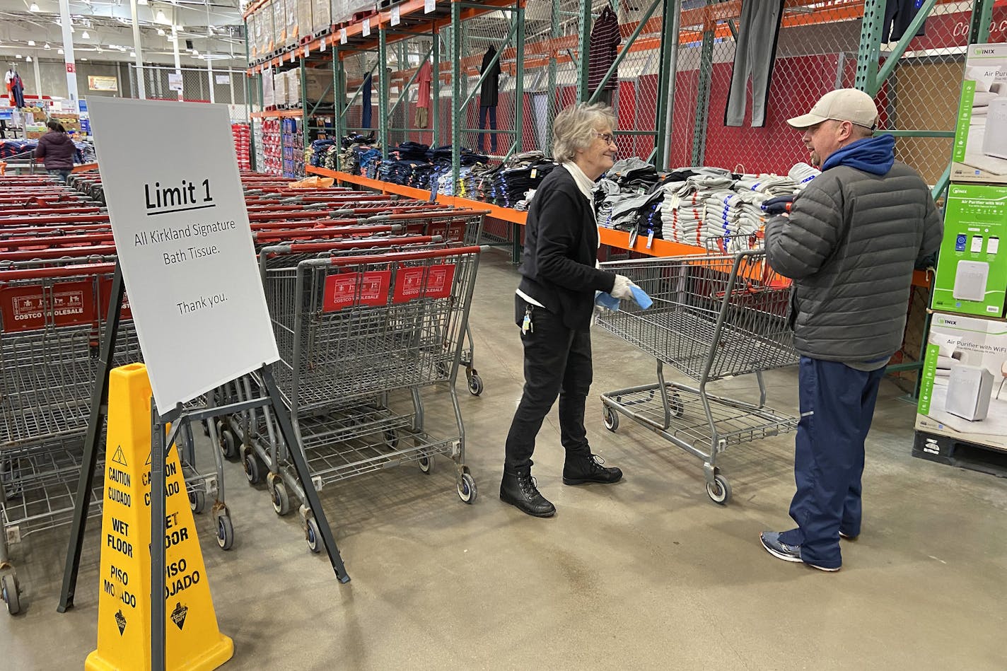 Staff greeted shoppers to disinfect their carts as a nearby sign alerted them to a limit on toilet paper Friday in Maple Grove, Minn. ] ANTHONY SOUFFLE &#x2022; anthony.souffle@startribune.com Shoppers flooded Costco stocking up on household items in response to the Coronavirus, prompting a limit on toilet paper and bottled water, Friday, March 13, 2020 in Maple Grove, Minn.