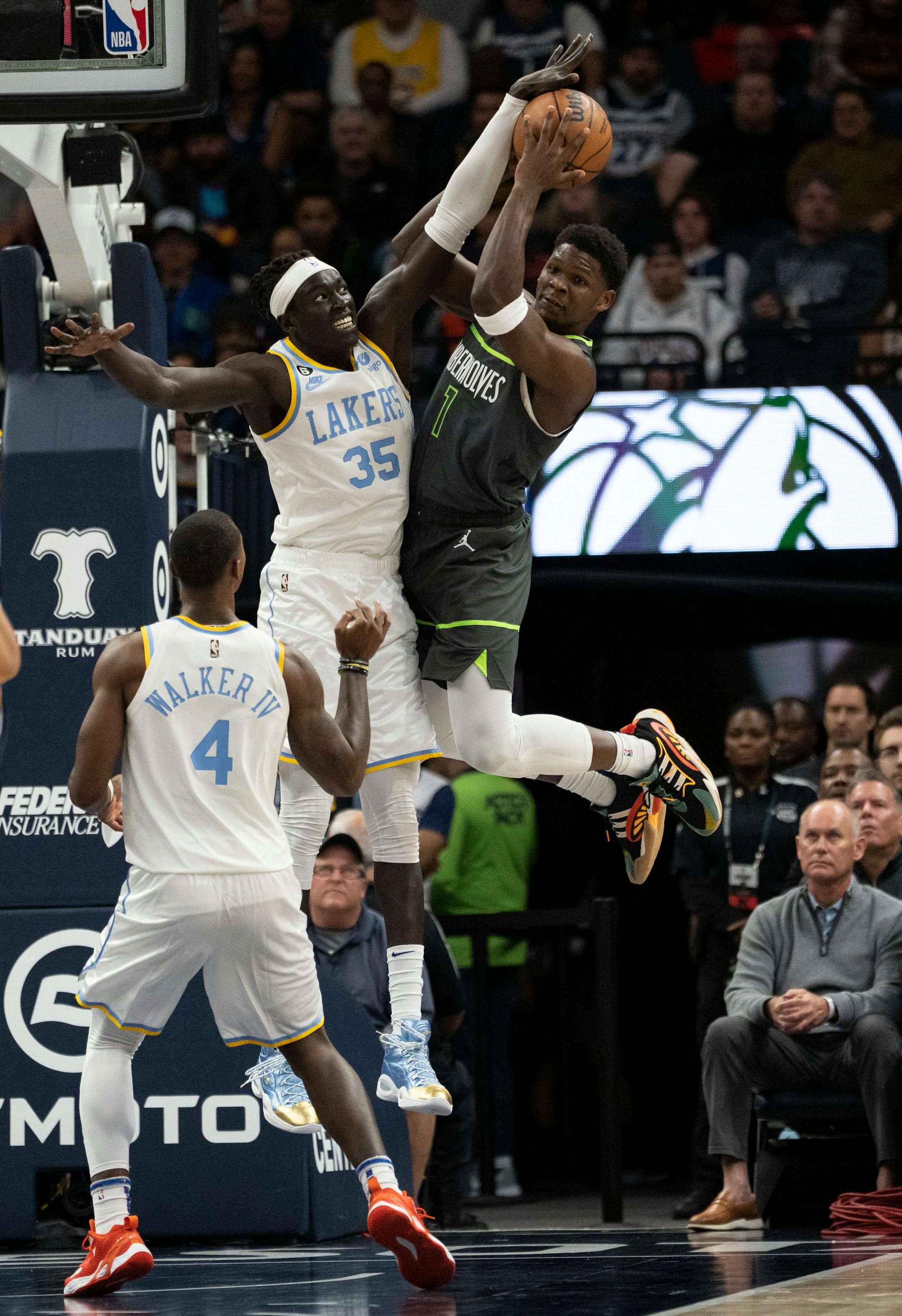 Minnesota Timberwolves forward Anthony Edwards (1) looks to pass while guarded by Los Angeles Lakers forward Wenyen Gabriel (35) in the first quarter.