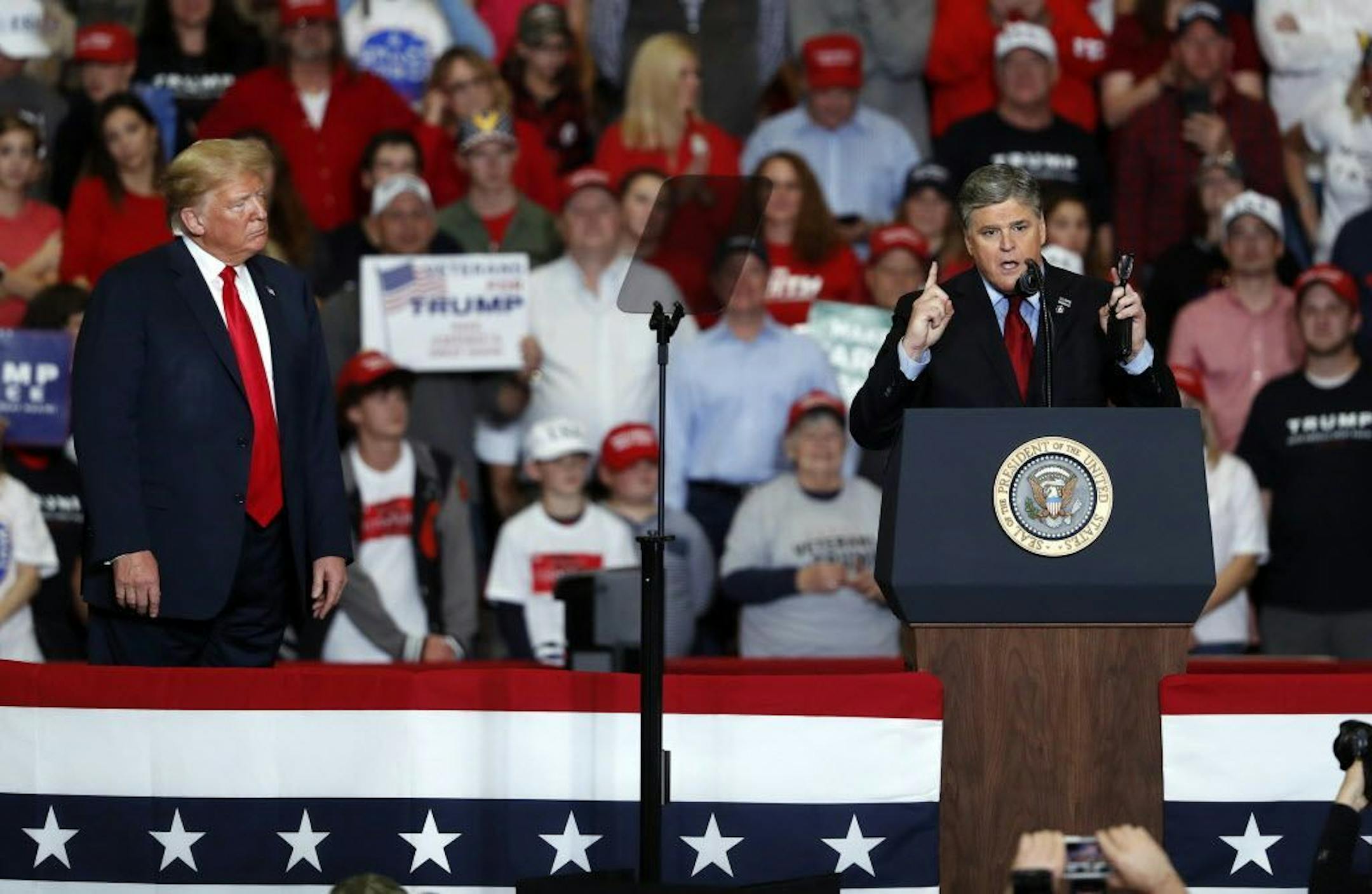 Television personality Sean Hannity, right, speaks as President Donald Trump listens during a campaign rally Monday, Nov. 5, 2018, in Cape Girardeau, Mo.