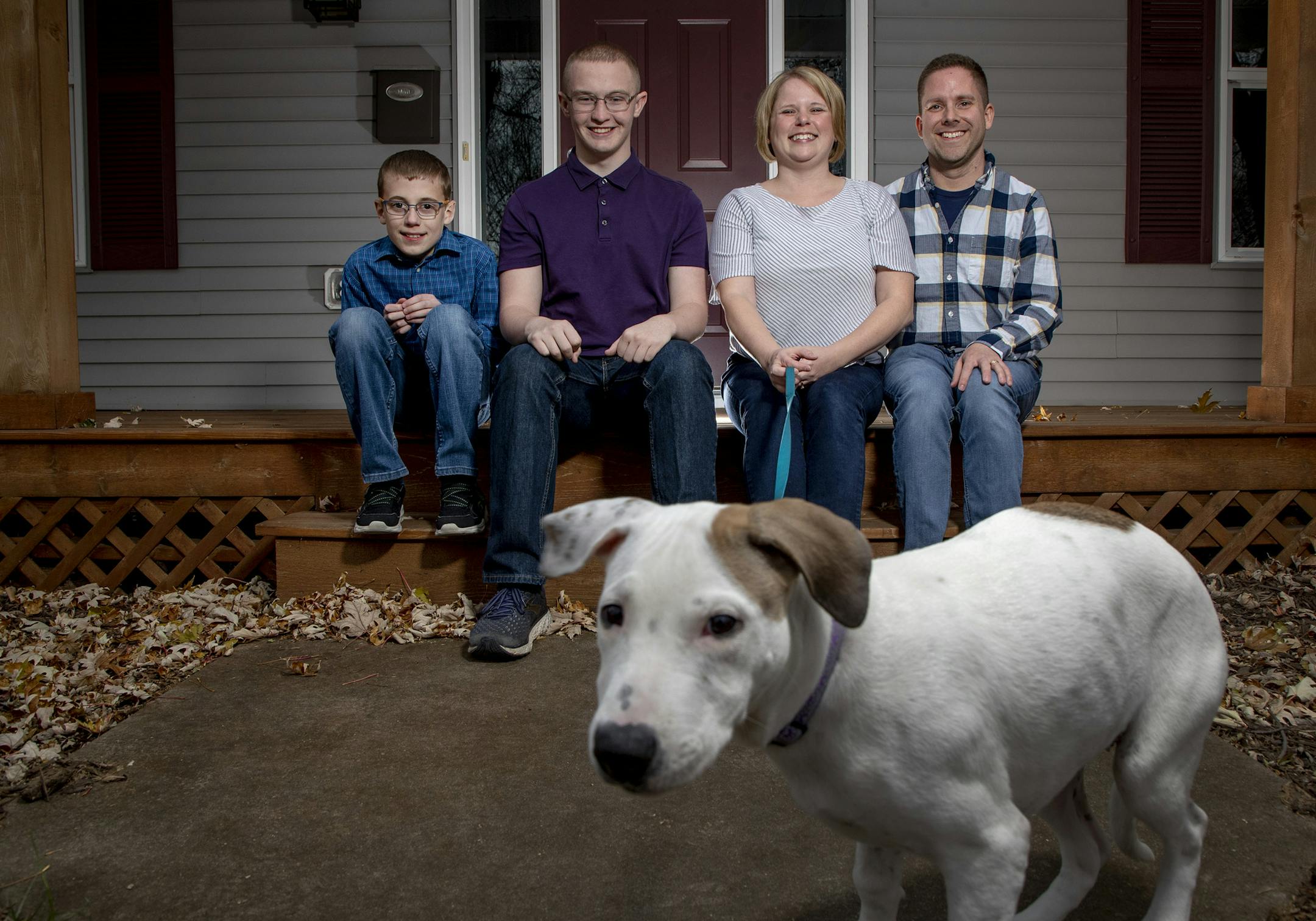 CJ Cummings, 12, Caleb McMurray, 16, Kari and Patrick Cummings photographed with their adopted dog Sadie from Ruff Start Rescue.