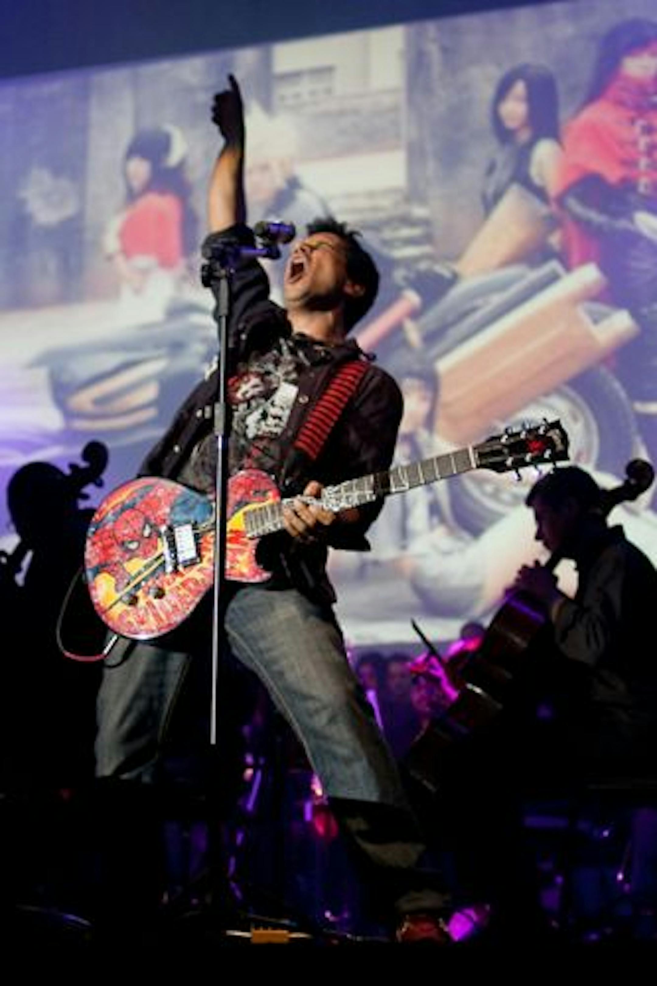 Tommy Tallarico, a composer and the host of "Video Games Live," played guitar with an orchestra during a previous engagement.