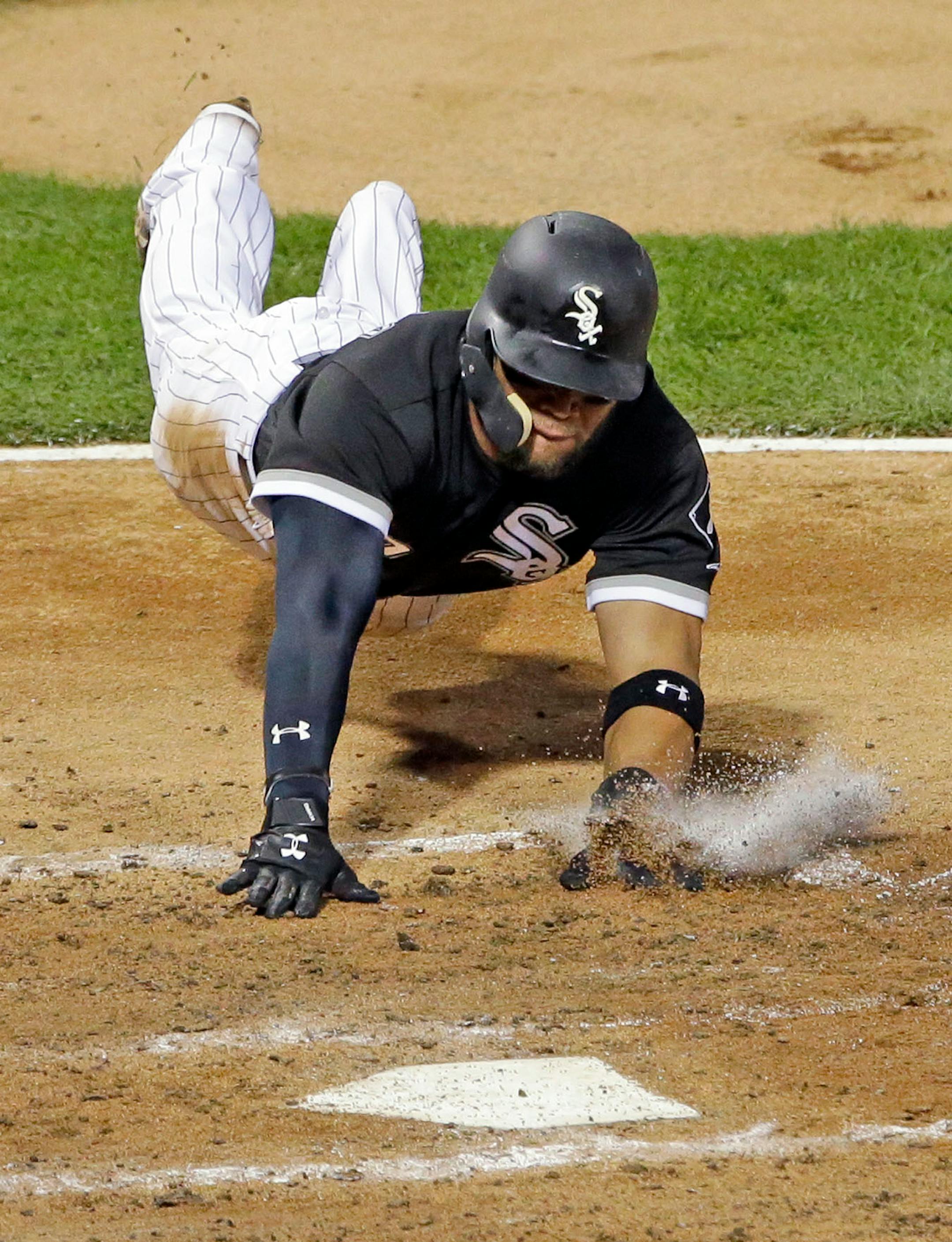 Chicago White Sox's Yoan Moncada scores against the Minnesota Twins during the fourth inning of a baseball game Thursday, Aug. 24, 2017, in Chicago.