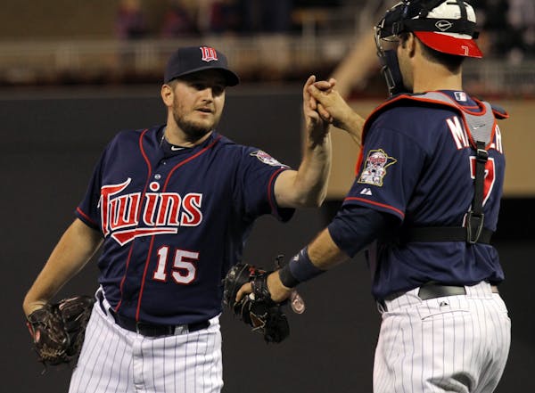 Pitcher Glen Perkins celebrated a Twins victory over Cleveland with catcher Joe Mauer.