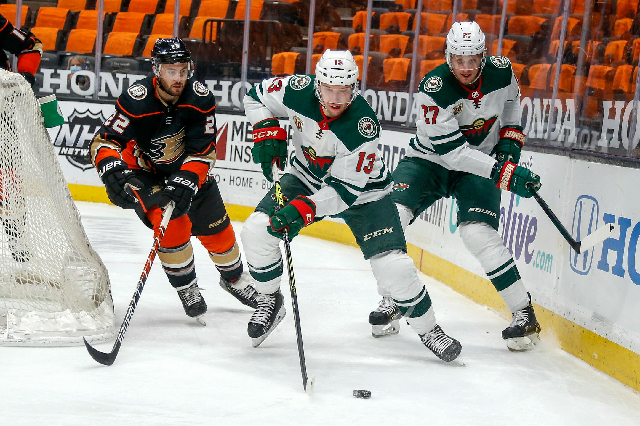 Wild forward Nick Bonino controls the puck between Nick Bjugstad and Ducks defenseman Kevin Shattenkirk