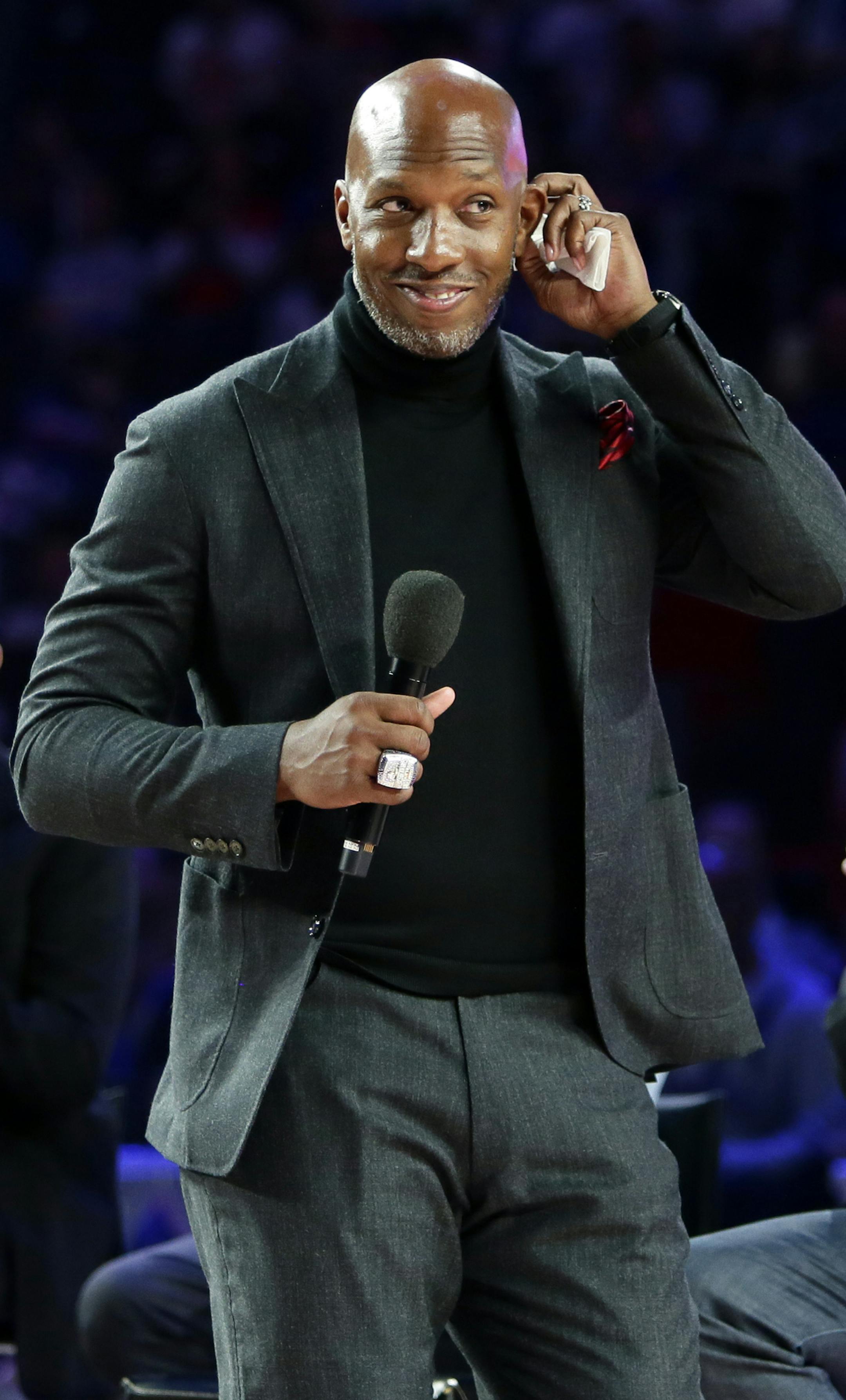 Former Detroit Piston Chauncey Billups, center, addresses fans at Little Caesars Arena while Richard Hamilton, left, and Ben Wallace look on during a celebration of their 2004 NBA Championship during halftime of an NBA basketball game against the Charlotte Hornets, Sunday, April 7, 2019, in Detroit. (AP Photo/Duane Burleson) ORG XMIT: MIDB106