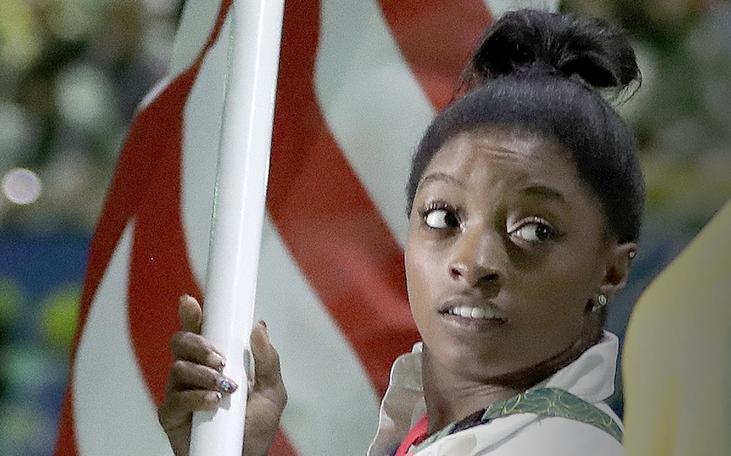 Simone Biles, who won four gold medals and a bronze in women's gymnastics competition, carried the flag of the United States during the Closing Ceremony in Maracana Stadium at the 2016 Summer Olympics in Rio de Janeiro on Sunday.