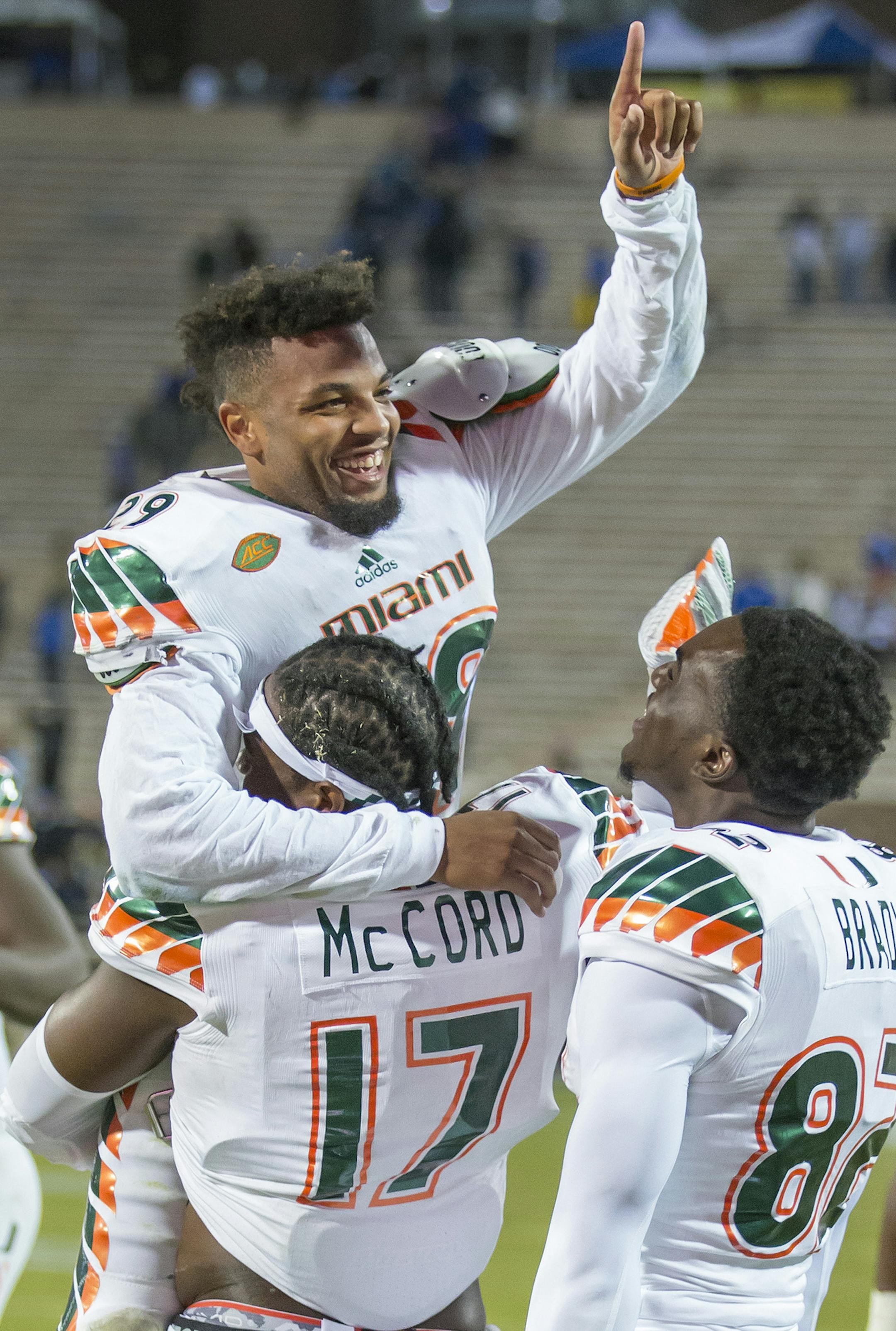 Miami's Corn Elder celebrates with teammate Tyriq McCord after he scored on a kickoff return to beat Duke 30-27 in an NCAA college football game, in Durham, N.C., Saturday, Oct. 31, 2015. (AP Photo/Rob Brown)