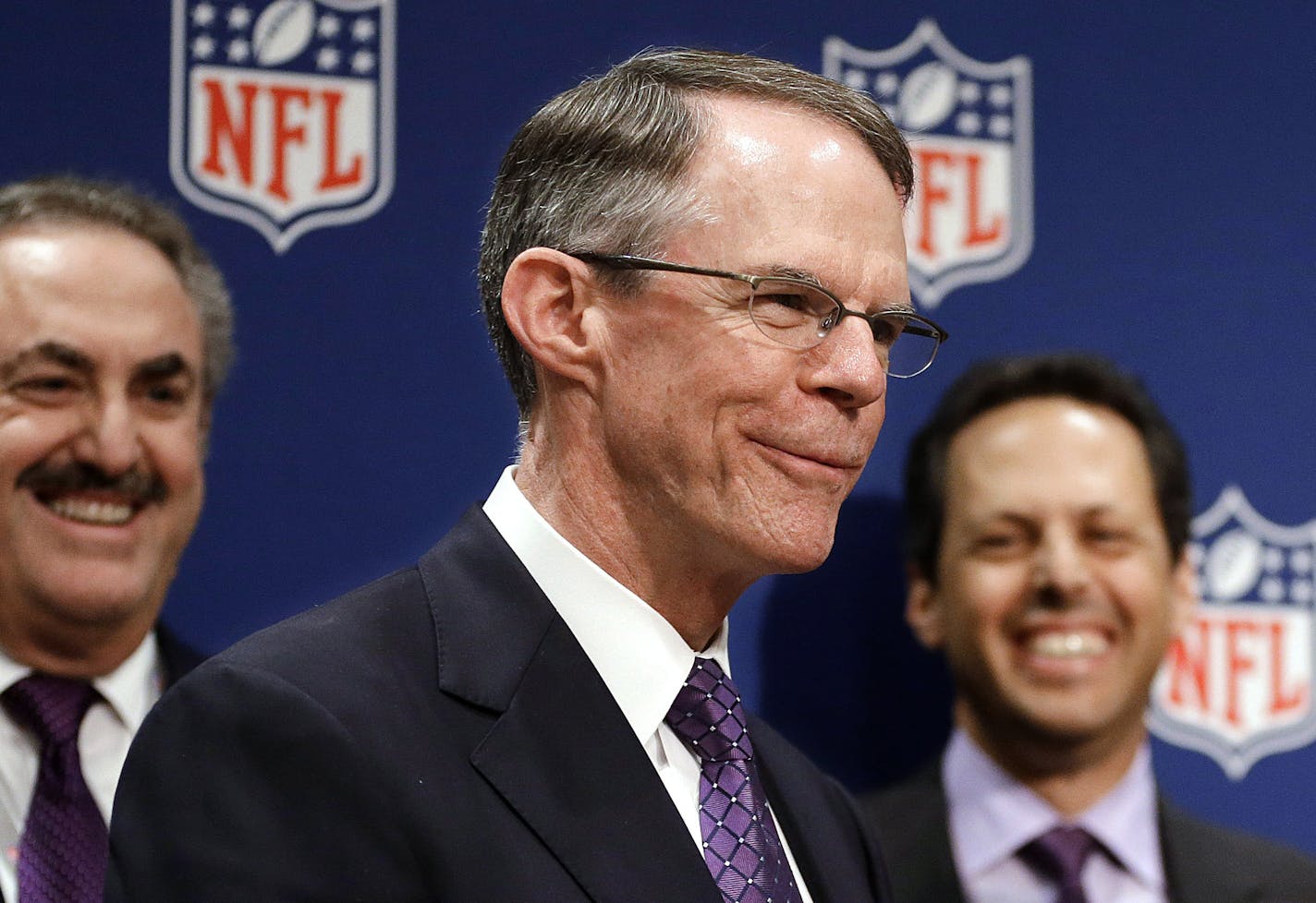 US Bancorp CEO Richard Davis (center) with Vikings owners Zygi Wilf and Mark Wilf.