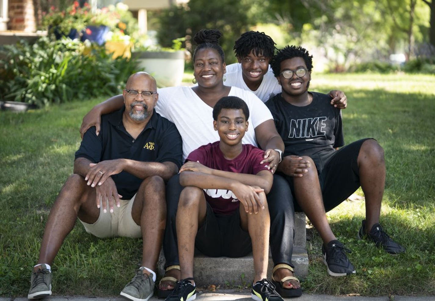 From the left; Charles Johnson-Nixon, Kirstin Johnson-Nixon, Raphael Johnson-Nixon, 13, Judah Johnson-Nixon, 13, and Caleb Johnson-Nixon, 17, posed for a picture in front of their home in Minneapolis, Minn., on Thursday, July 23, 2020. The whole family, including grandparents who are not picture, got sick with Covid-19 in May. Charles and Kirstin were sick in bed and Kristin's parents hospitalized. The children had mild symptoms or were asymptomatic