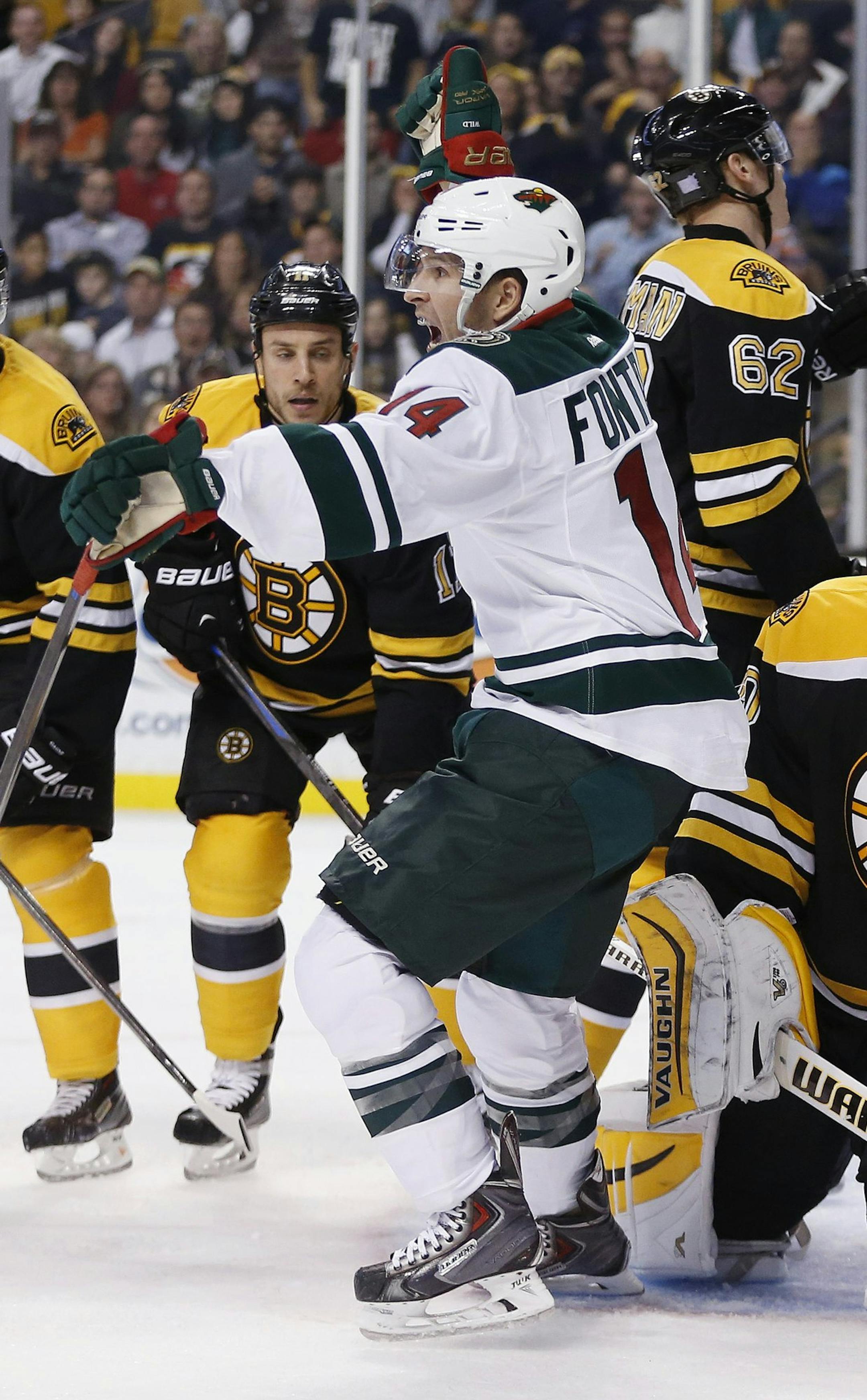 Minnesota Wild right wing Justin Fontaine (14) celebrates his goal on Boston Bruins goalie Tuukka Rask, of Finland, right, in the third period of an NHL hockey game in Boston, Tuesday, Oct. 28, 2014. The Wild won 4-3. (AP Photo/Michael Dwyer)