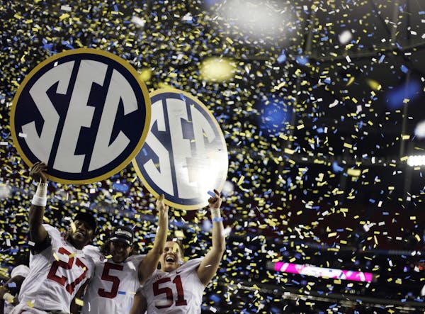 FILE - In this Dec. 1, 2012, file photo, Alabama players, from left, Nick Perry, Jeremy Shelley, and Carson Tinker celebrate after their 32-28 win in 