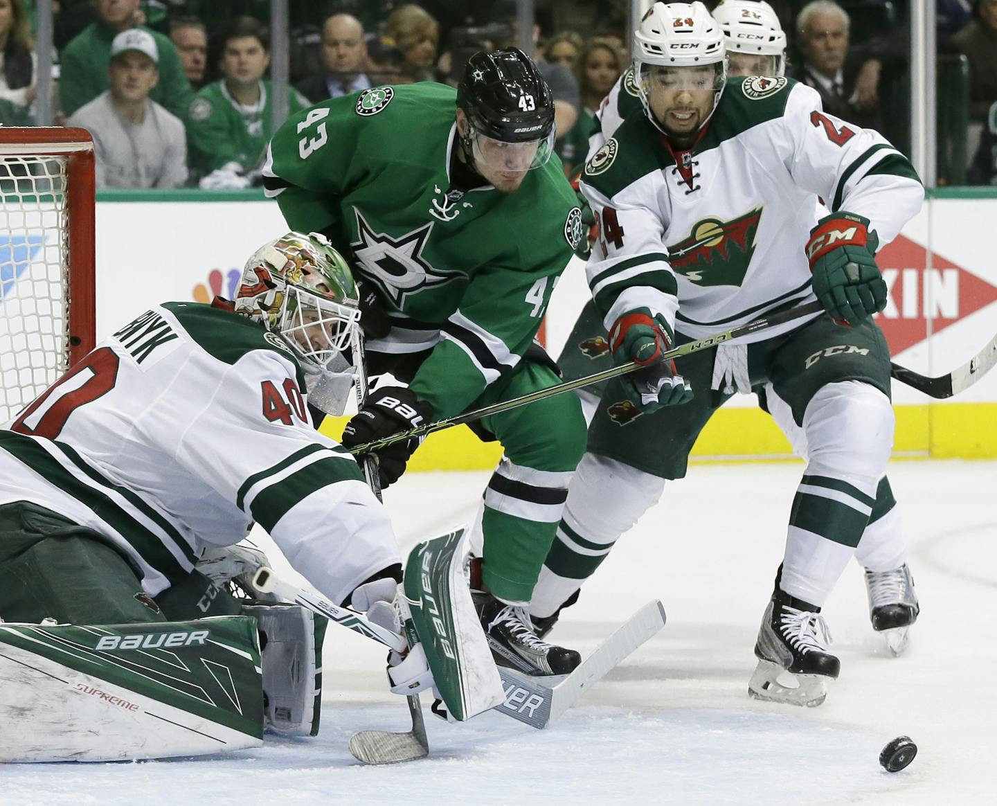 Minnesota Wild goalie Devan Dubnyk (40) and defenseman Matt Dumba (24) defend the goal against Dallas Stars right wing Valeri Nichushkin