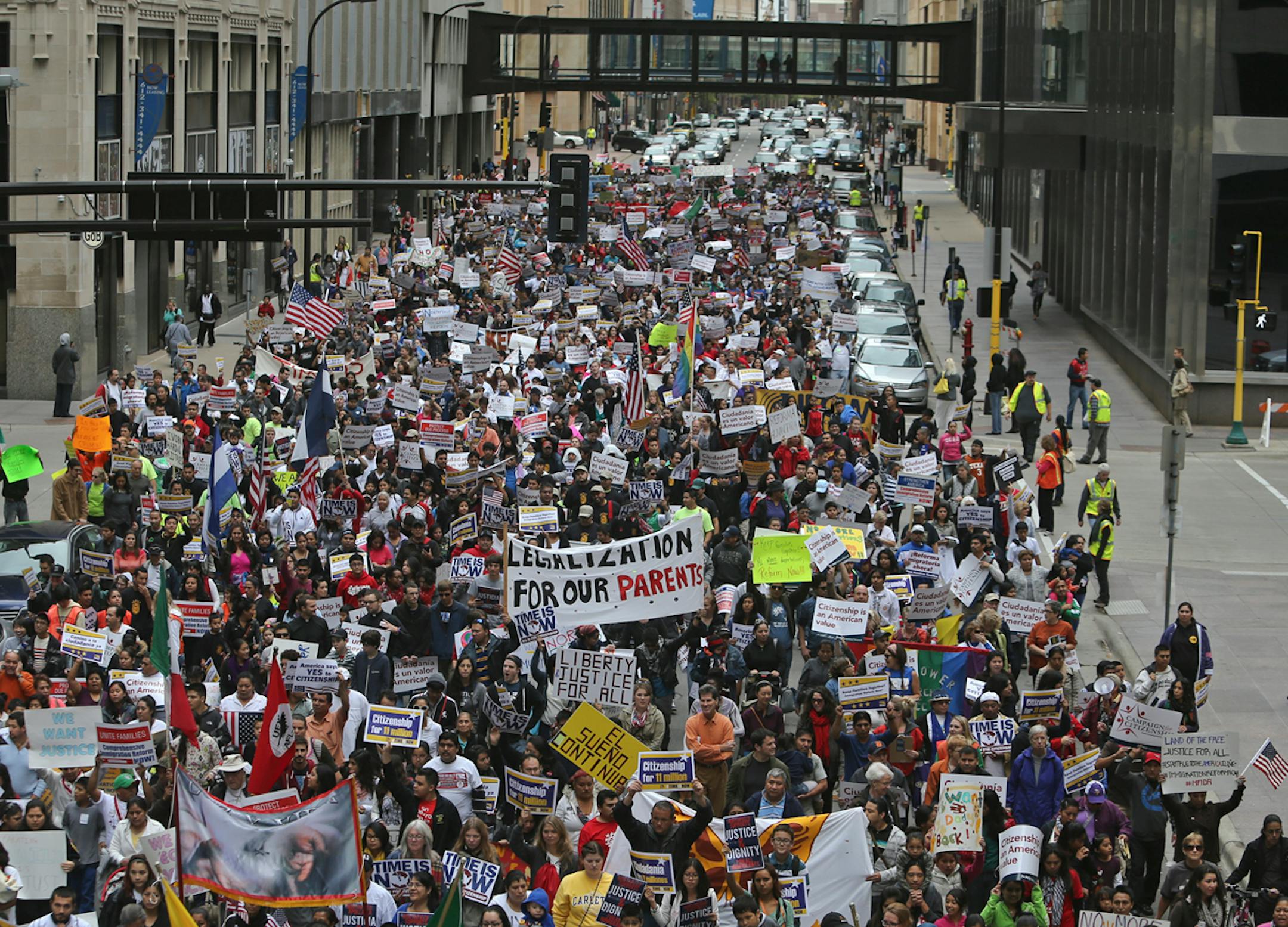 Thousands of immigration reformers clogged the streets of 6th St. in downtown Minneapolis while marching from the Basilica of St. Mary to to the Hennepin County Government Center Plaza Saturday, Oct. 5, 2013, in Minneapolis, MN.