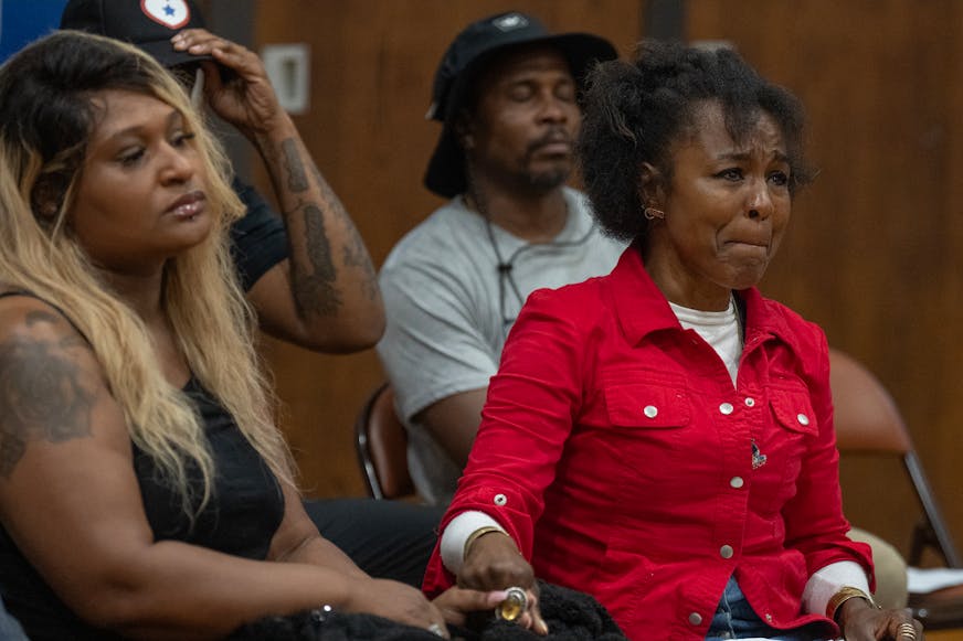 Toshira Garraway Allen, left, and Princess Titus, right, hold hands during a June 25 press conference in Minneapolis to address violence by kids, two days after 11-year-old Amir Atkins was shot and killed at Folwell Park.