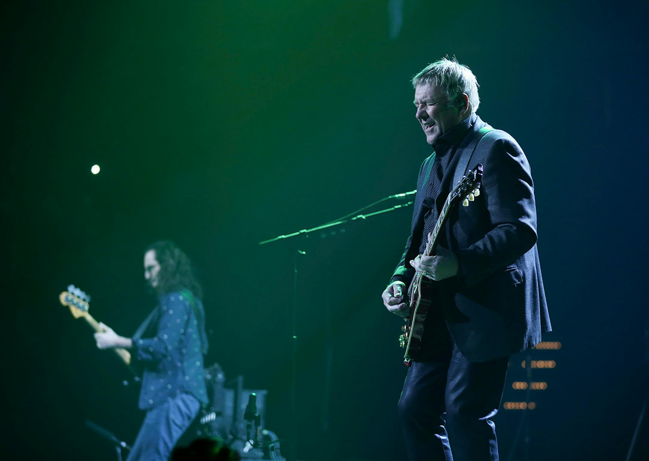 Guitarist Alex Lifeson soloed in the foreground while bassist Geddy Lee worked the crowd Tuesday night. ] JEFF WHEELER ï jeff.wheeler@startribune.com Canadian rock gods Rush performed at Xcel Energy Center in St. Paul, Tuesday night, May 12, 2015.