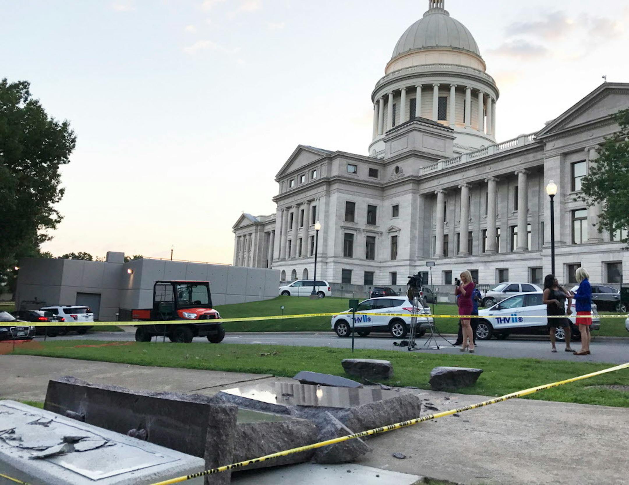 The new Ten Commandments monument outside the state Capitol in Little Rock, Ark., is blocked off Wednesday morning, June 28, 2017, after someone crashed into it with a vehicle, less than 24 hours after the privately funded monument was placed on the Capitol grounds. Authorities arrested a male suspect. (AP Photo/Jill Zeman Bleed)