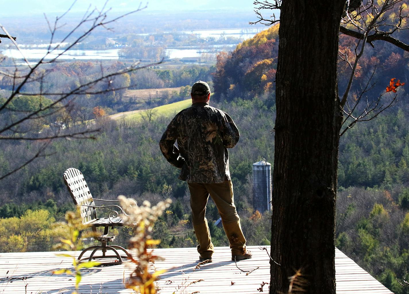 A Buffalo County landowner and deer hunter who asked not to be identified looks out over his hunting and forest land from an observation deck high above the Upper Mississippi River Valley, near Alma, Wisc.