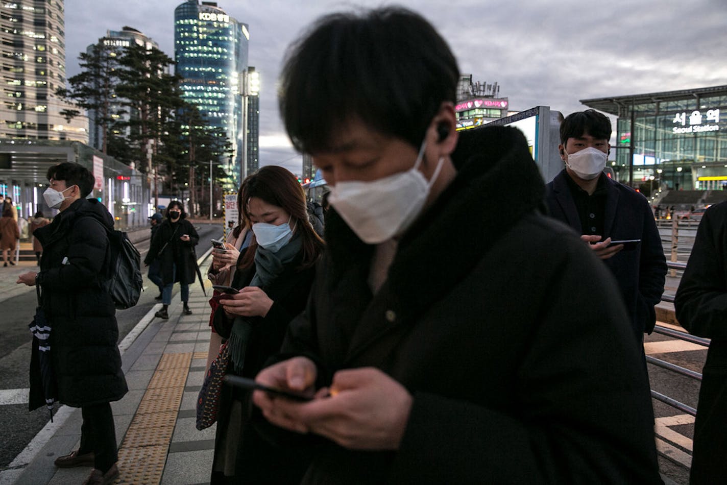 Pedestrians wearing masks in downtown Seoul, South Korea on Tuesday, Feb. 25, 2020. Americans should brace for the likelihood that the coronavirus will spread to communities in the United States, health officials in Minnesota and the U.S. warned Tuesday.