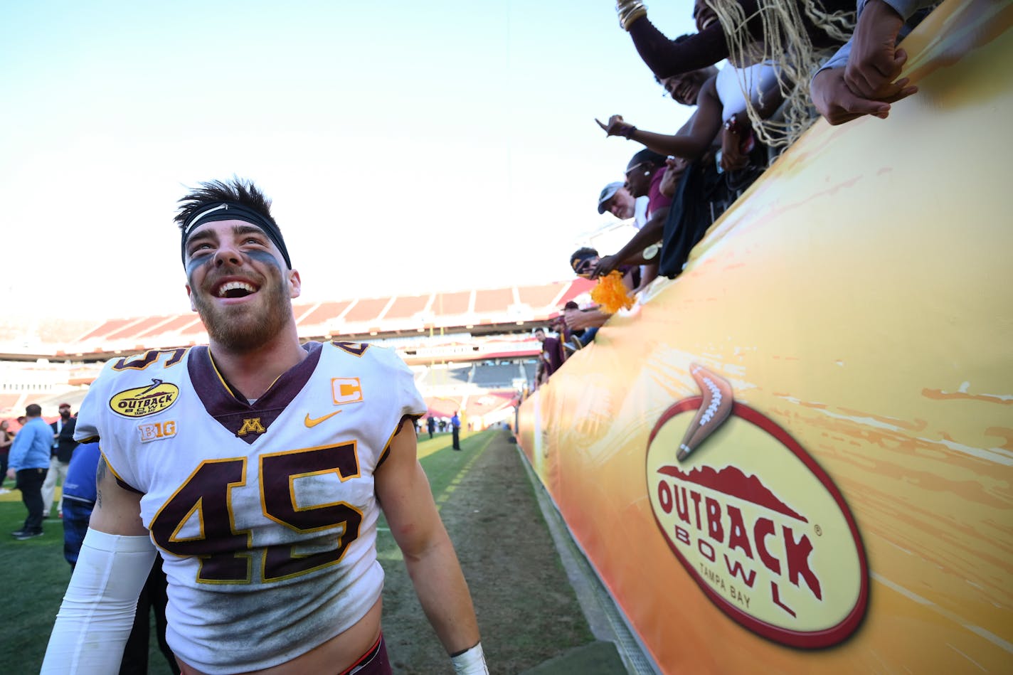 Gophers linebacker Carter Coughlin (45) was all smiles as he walked off the field following his team's 31-24 victory over Auburn in the Outback Bowl on Wednesday.