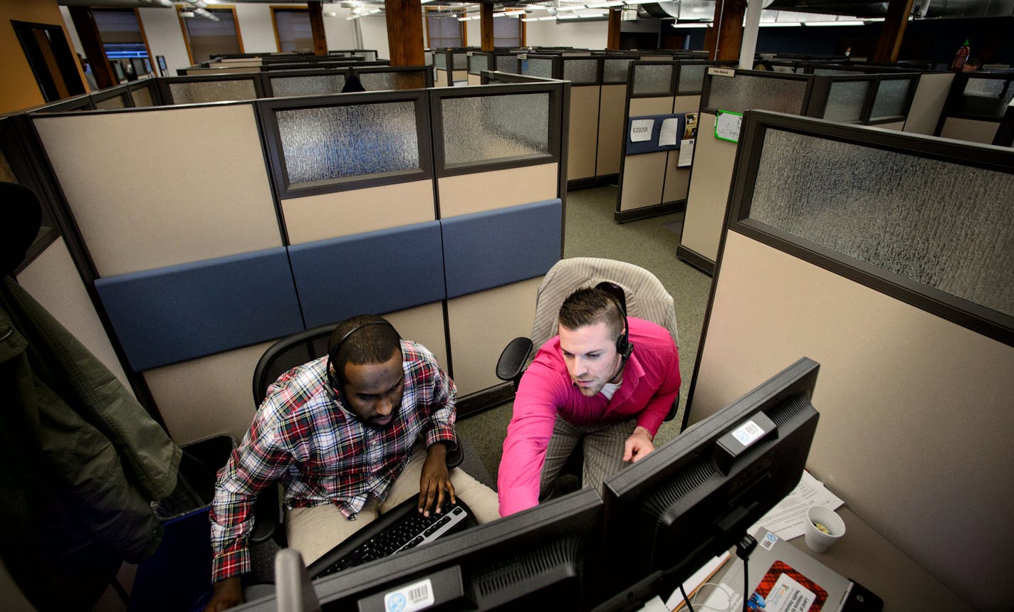 Abdikarim Abdi and Josh Truax took calls and worked on training in the MNsure call center in St. Paul.