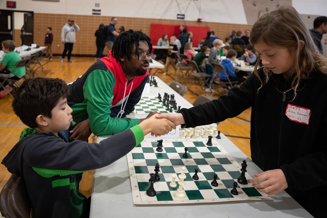 Jasper Benson Loesch, right, shook hands with Theodore Williams at the end of a match at the Check it Out chess tournament.
