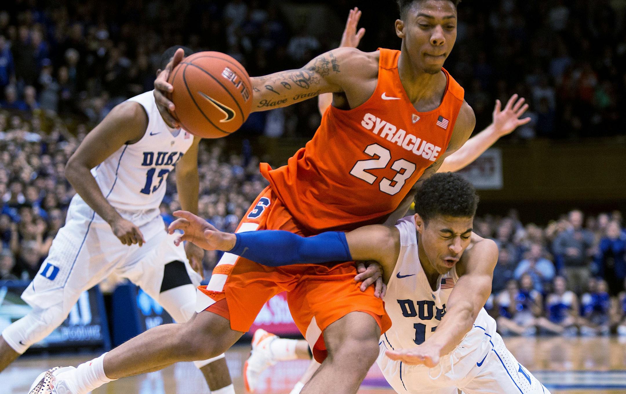 Syracuse&#x2019;s Malachi Richardson (23) handles the ball as Duke&#x2019;s Derryck Thornton, right, dives during the second half of an NCAA college basketball game at Cameron Indoor Stadium in Durham, N.C., Monday, Jan. 18, 2016. Syracuse defeated Duke 64-62. (AP Photo/Ben McKeown)