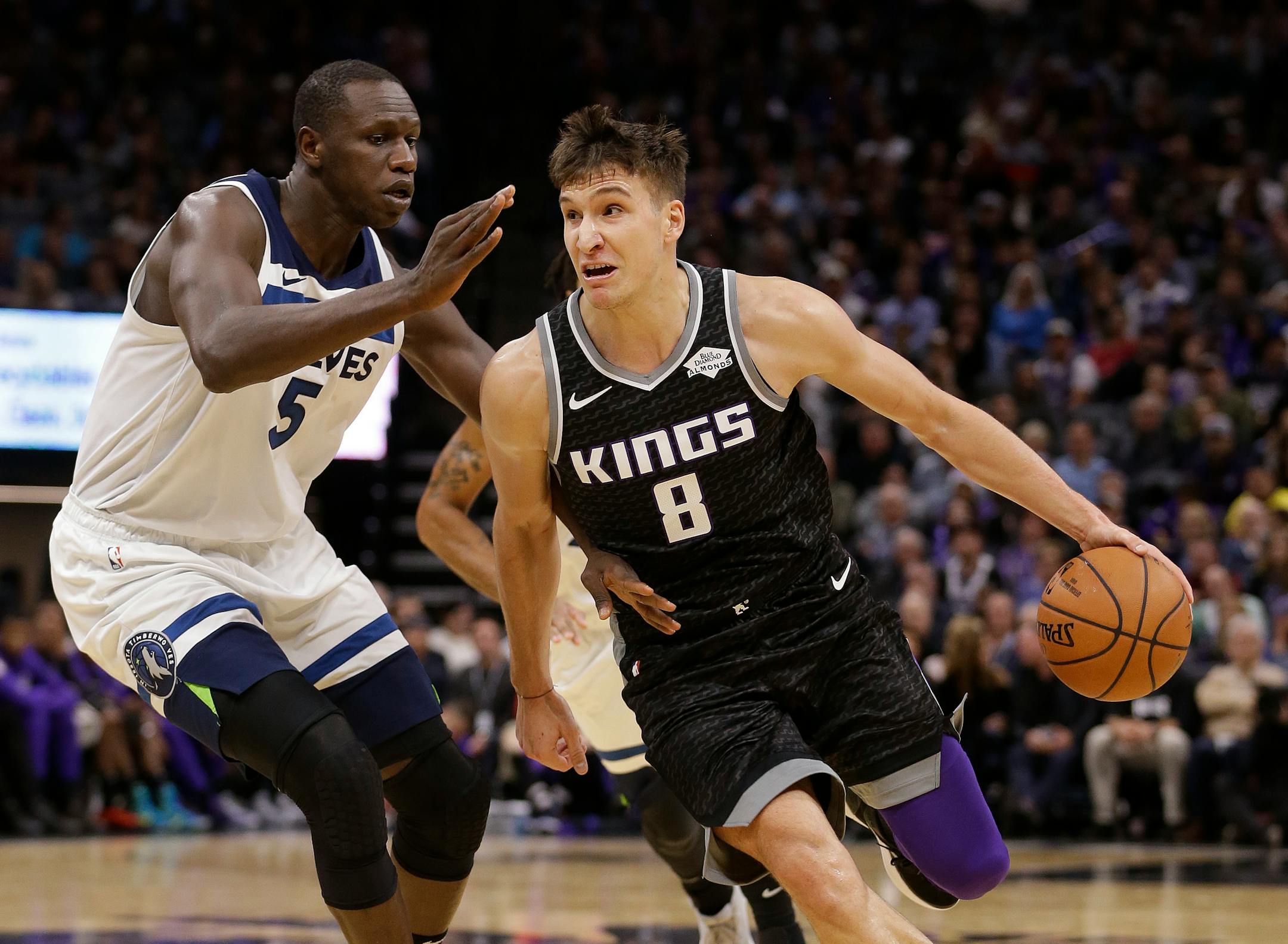 Kings guard Bogdan Bogdanovic, right, drives against Timberwolves center Gorgui Dieng during the second half