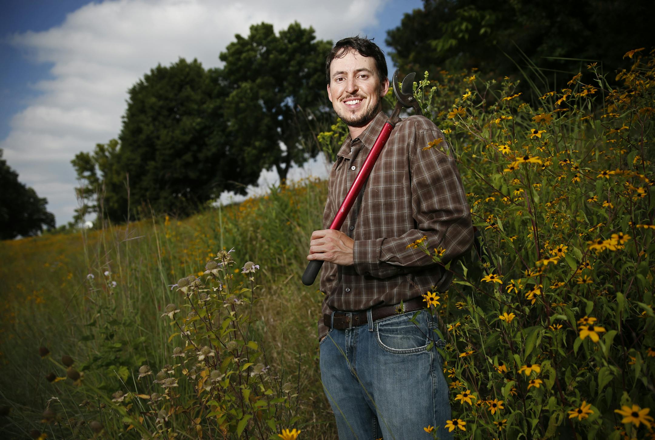 On Nicollet Ave South near the Civic Center, the city of Burnsville has turned an entire hillside in front of city hall from turf grass to a beautiful field of prairie grasses and wild flowers. Caleb Ashling is the naturalist who takes care of this land.]tsong-taataarii@startribune.com