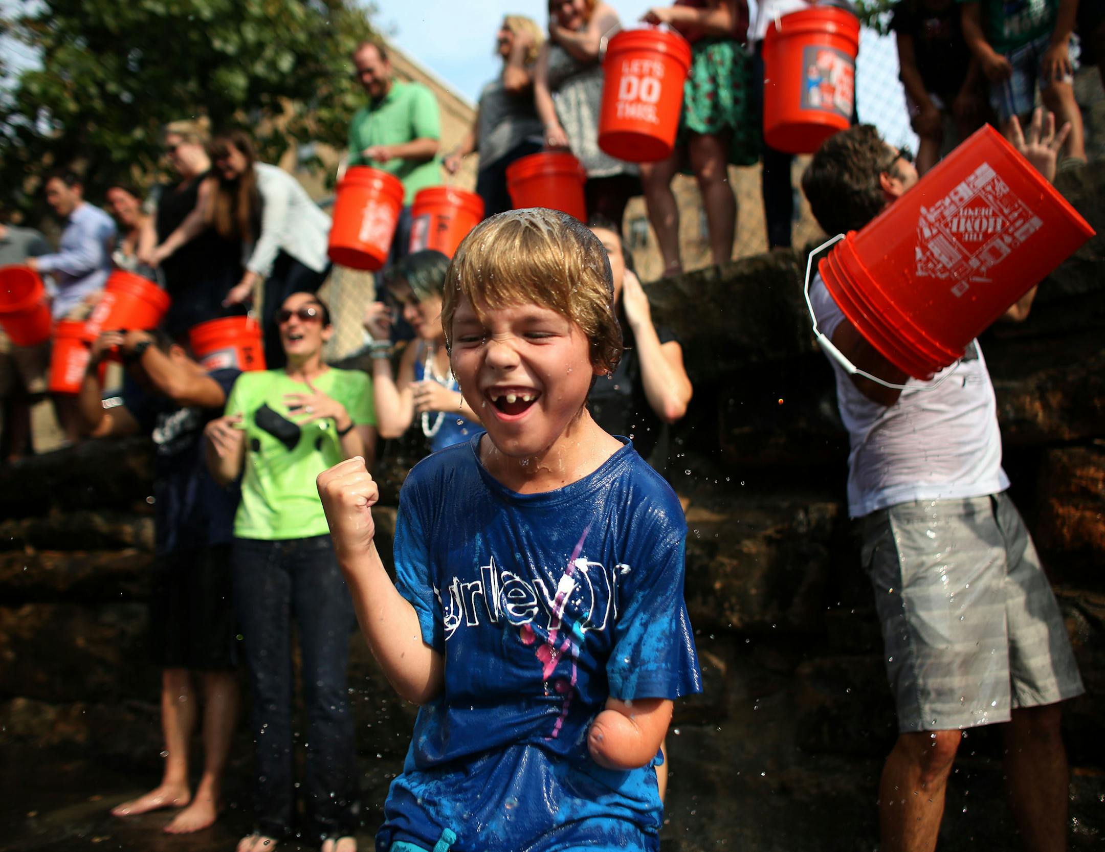 Caleb Peterson, 9, family friend of owner Billy Jurewicz, celebrated along with employees of space150 ad agency, after taking the ice bucket challenge for ALS. ] (KYNDELL HARKNESS/STAR TRIBUNE) kyndell.harkness@startribune.com In a parking lot behind the building that houses space150 ad agency in Minneapolis Min., wednesday, August, 20, 2014. About 20 staff members at space150 ad agency in Minneapolis will be taking on the ice bucket challenge.