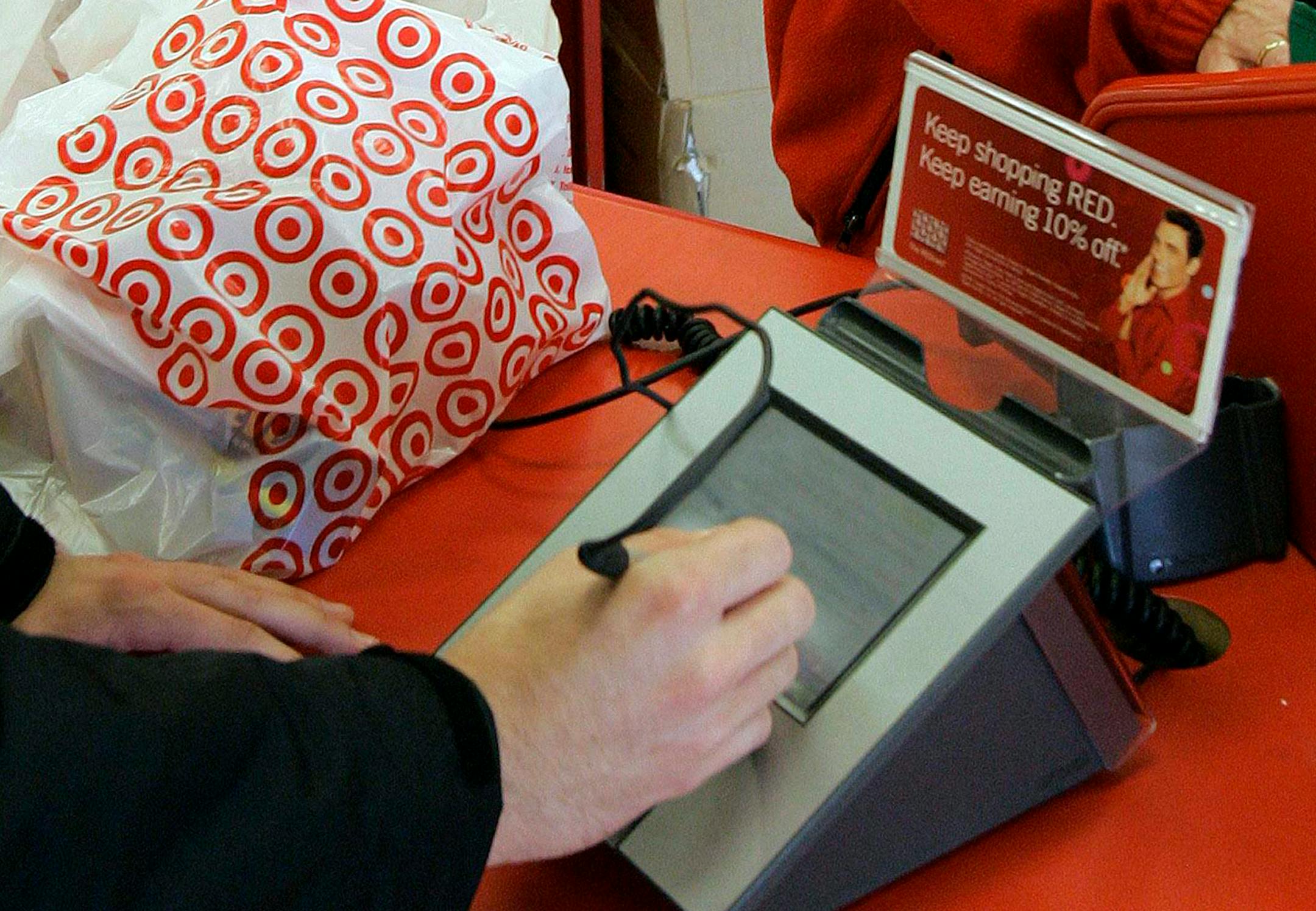 A customer signs his credit card receipt at a Target store in Tallahassee, Fla.