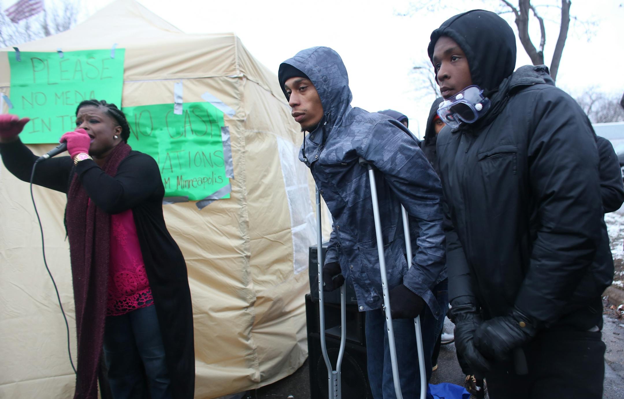 NAACP Minneapolis president Nekima Levy-Pounds introduced Cameron Clark, left and Wesley Martin who two of the victims shot Monday night during BlackGiving event in front of the Minneapolis Fourth Precinct.