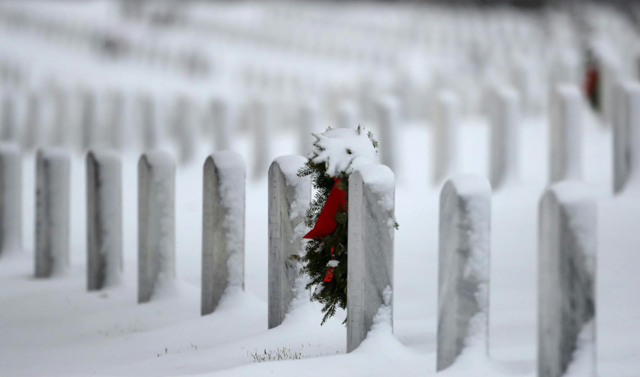 Fresh snow covers grave stones and a Christmas wreath at Fort Snelling National Cemetery Saturday, Nov. 30, 2019, in Minneapolis, MN.] DAVID JOLES &#x2022; david.joles@startribune.com The second round of November snowstorm