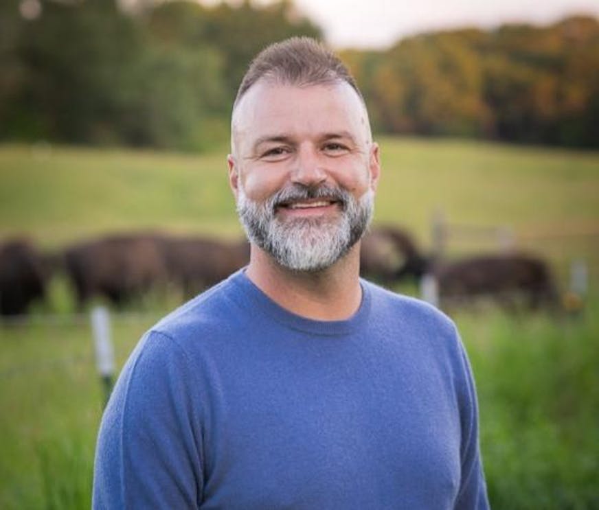 photo of author Nickolas Butler, standing in a field