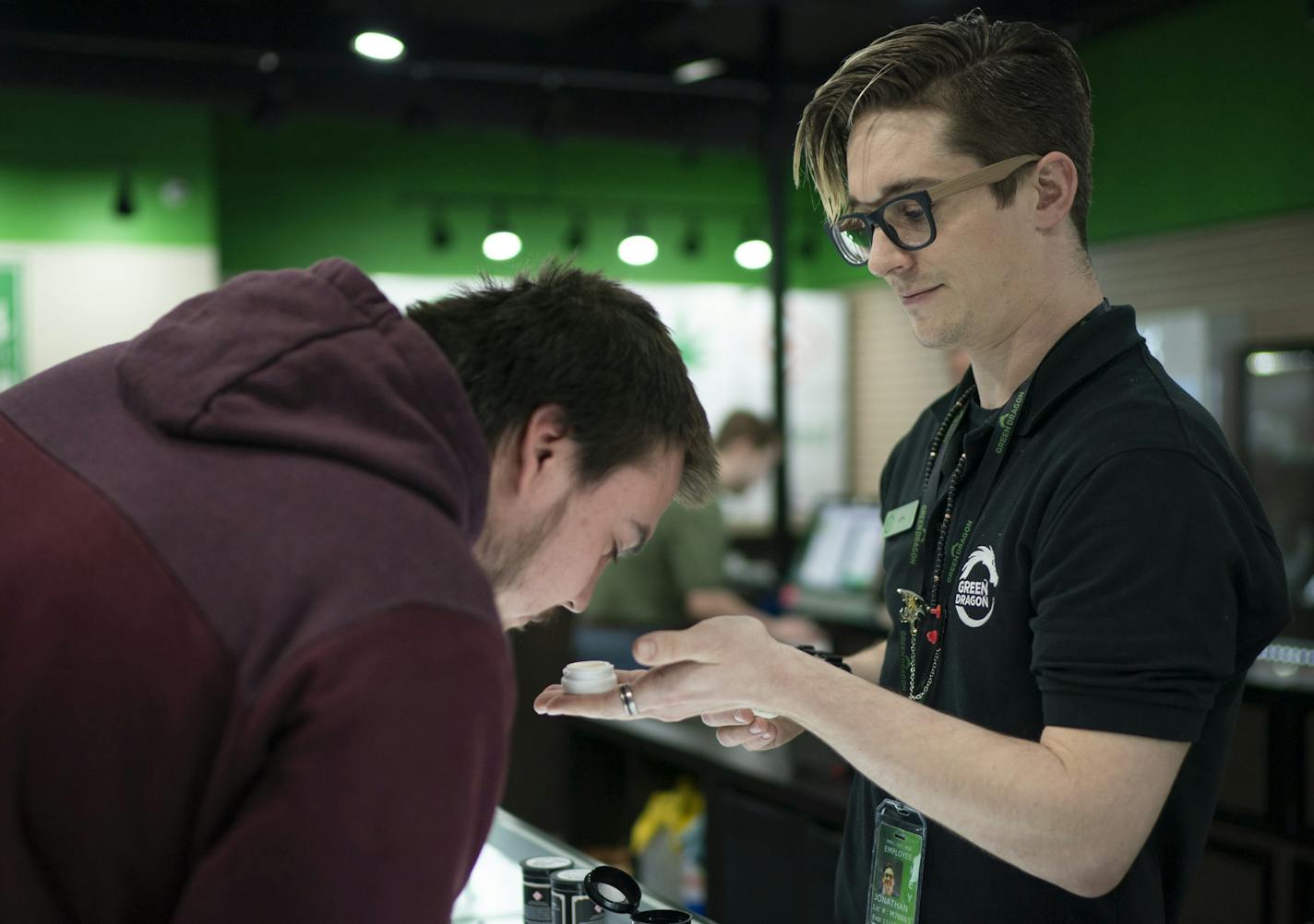 Jon Haus, a native of Champlin Park, helped a customer at the dispensary he manages in Denver. Some in Colorado warn legalization normalizes use, especially among kids.