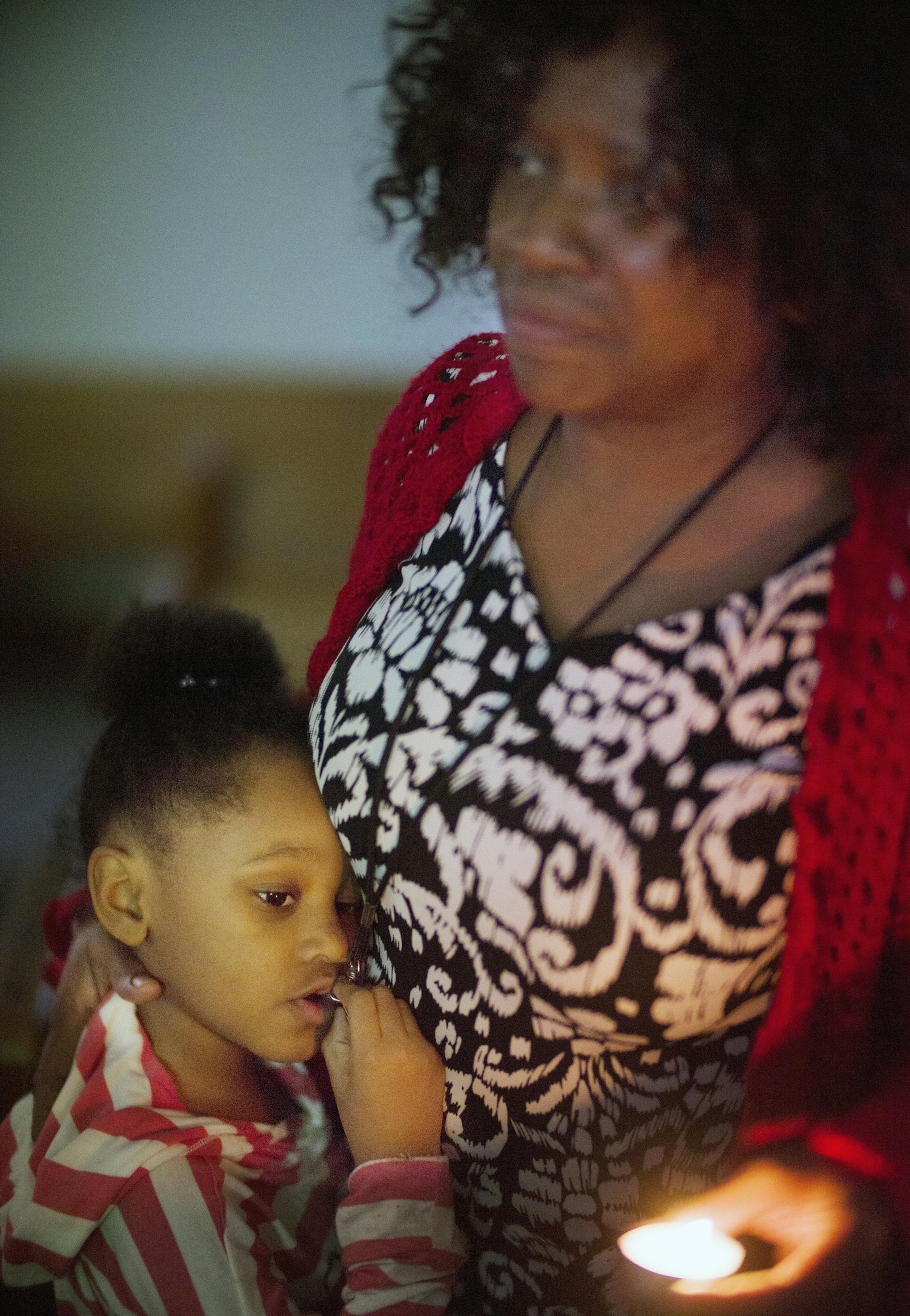 At Holsey Memorial CME Church where a vigil was held for the three children who died in house fire, Ianece McCraney,6, and her grandmother Jeraine Cuff paid to their Northside community members.] Richard Tsong-Taatarii/rtsong-taatarii@startribune.com