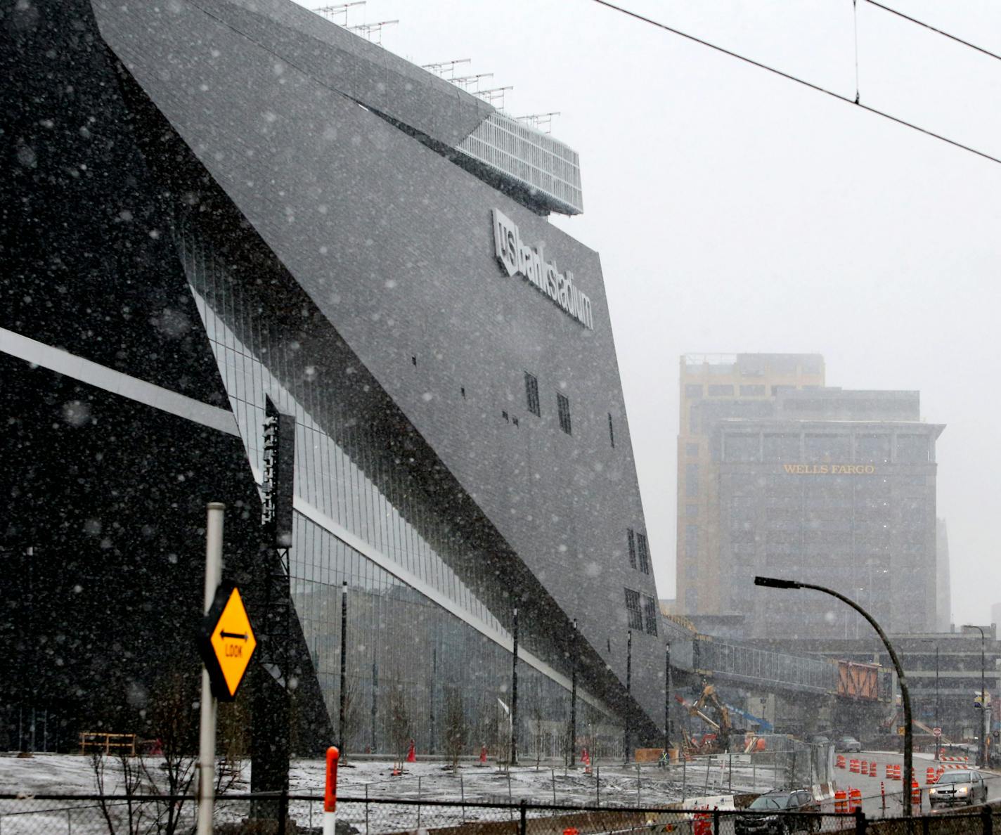 U.S. Bank Stadium is shown with the Wells Fargo towers to the north, seen from 11th Avenue S. in Minneapolis. The Wells Fargo towers have signage on their rooftops that has come under dispute with the Vikings.