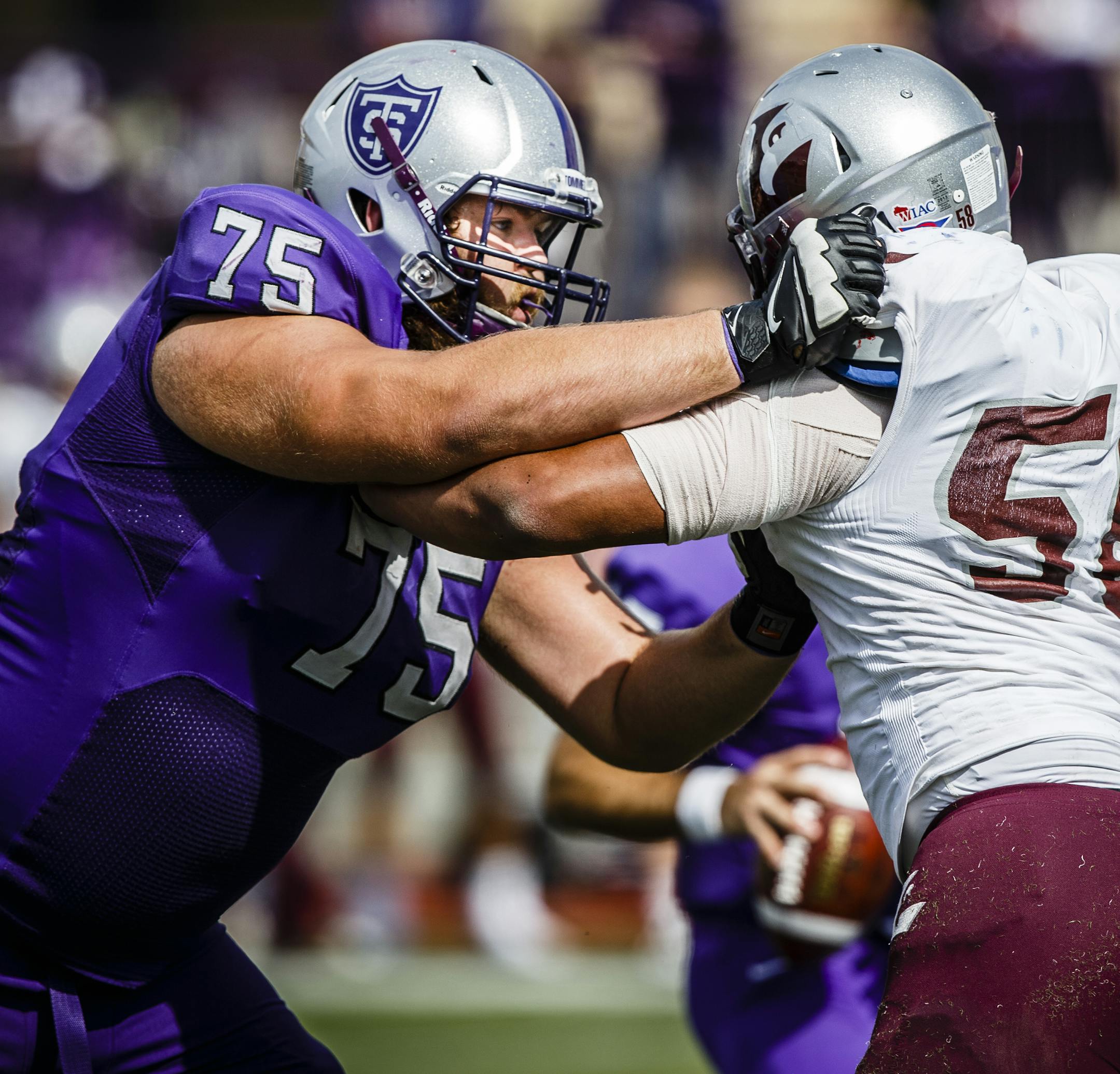 David Simmet (75) and Zach Brennan block during a football game against the University of Wisconsin-La Crosse September 13, 2014 in O'Shaughnessy Stadium. The Tommies won 46-0.