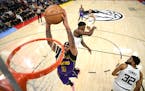 Los Angeles Lakers forward Anthony Davis (3) dunks the ball against Minnesota Timberwolves guard Anthony Edwards (1) and center Karl-Anthony Towns (32