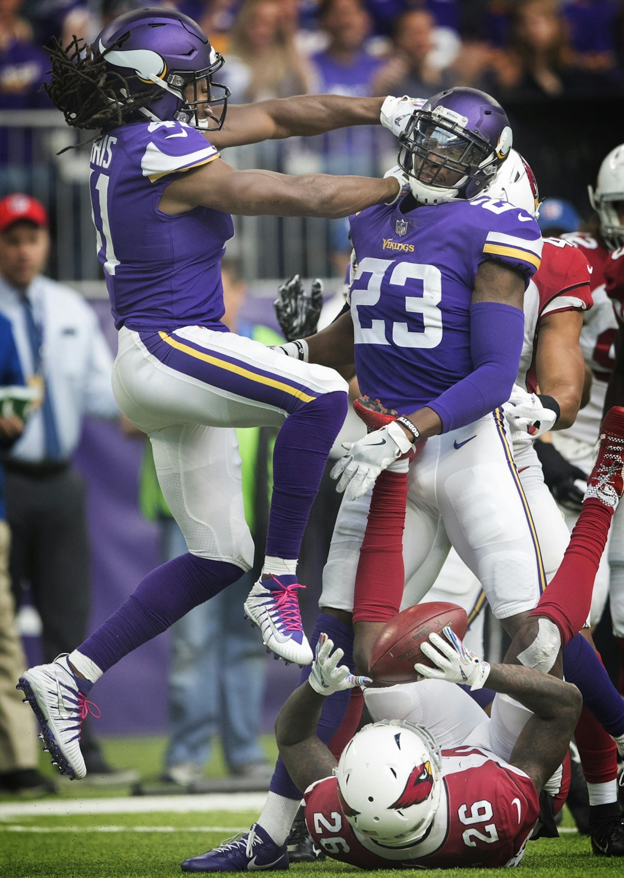 Minnesota Vikings defensive back Anthony Harris (41) left celebrated after defensive back George Iloka (23) stuffed Arizona Cardinals cornerback Brandon Williams (26) in the forth quarter at U.S. Bank Stadium Sunday October 14, 2018 in Minneapolis, MN.
