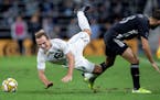 Chase Gasper (77) of Minnesota United and Graham Zusi (8) of Sporting Kansas City collided in the first half of a match last Sept. 25 at Allianz Field