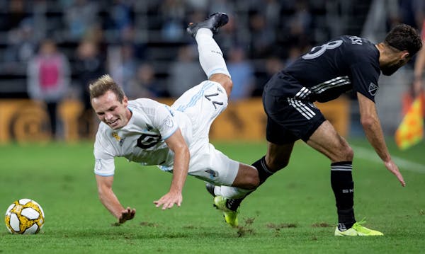 Chase Gasper (77) of Minnesota United and Graham Zusi (8) of Sporting Kansas City collided in the first half of a match last Sept. 25 at Allianz Field