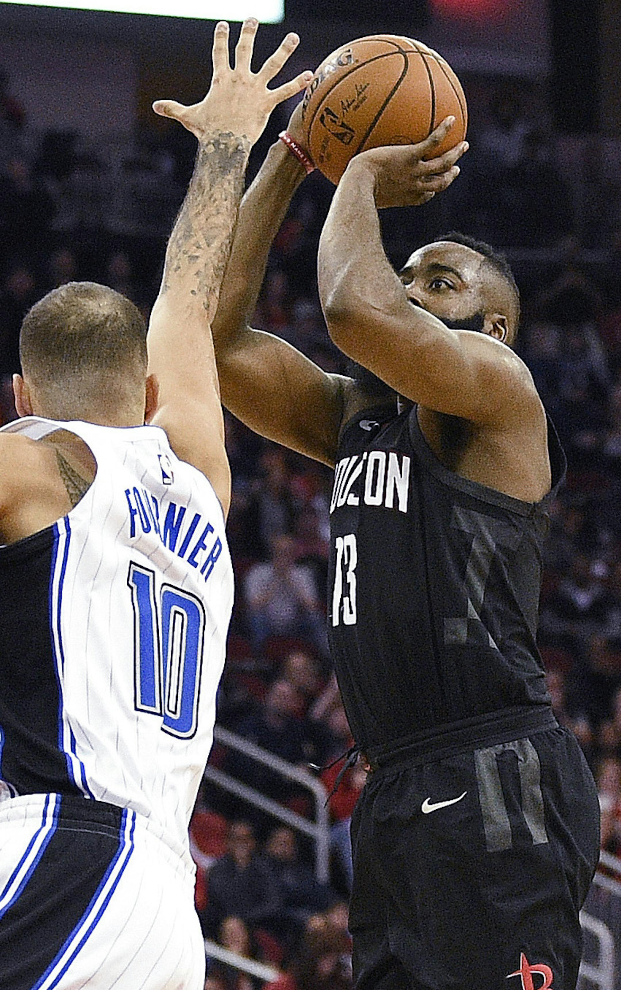 Houston Rockets guard James Harden, right, shots a 3-pointer as Orlando Magic forward Evan Fournier defends during the second half of an NBA basketball game Tuesday, Jan. 30, 2018, in Houston. Houston won 114-107. (AP Photo/Eric Christian Smith)