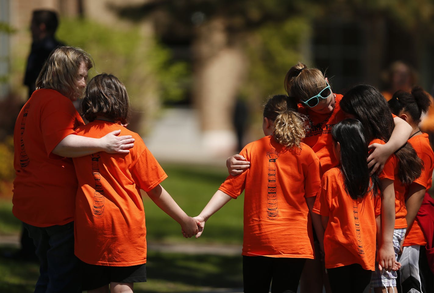 Students and staff supported each other as they gathered for the memorial outside Peter Hobart Elementary School Thursday.