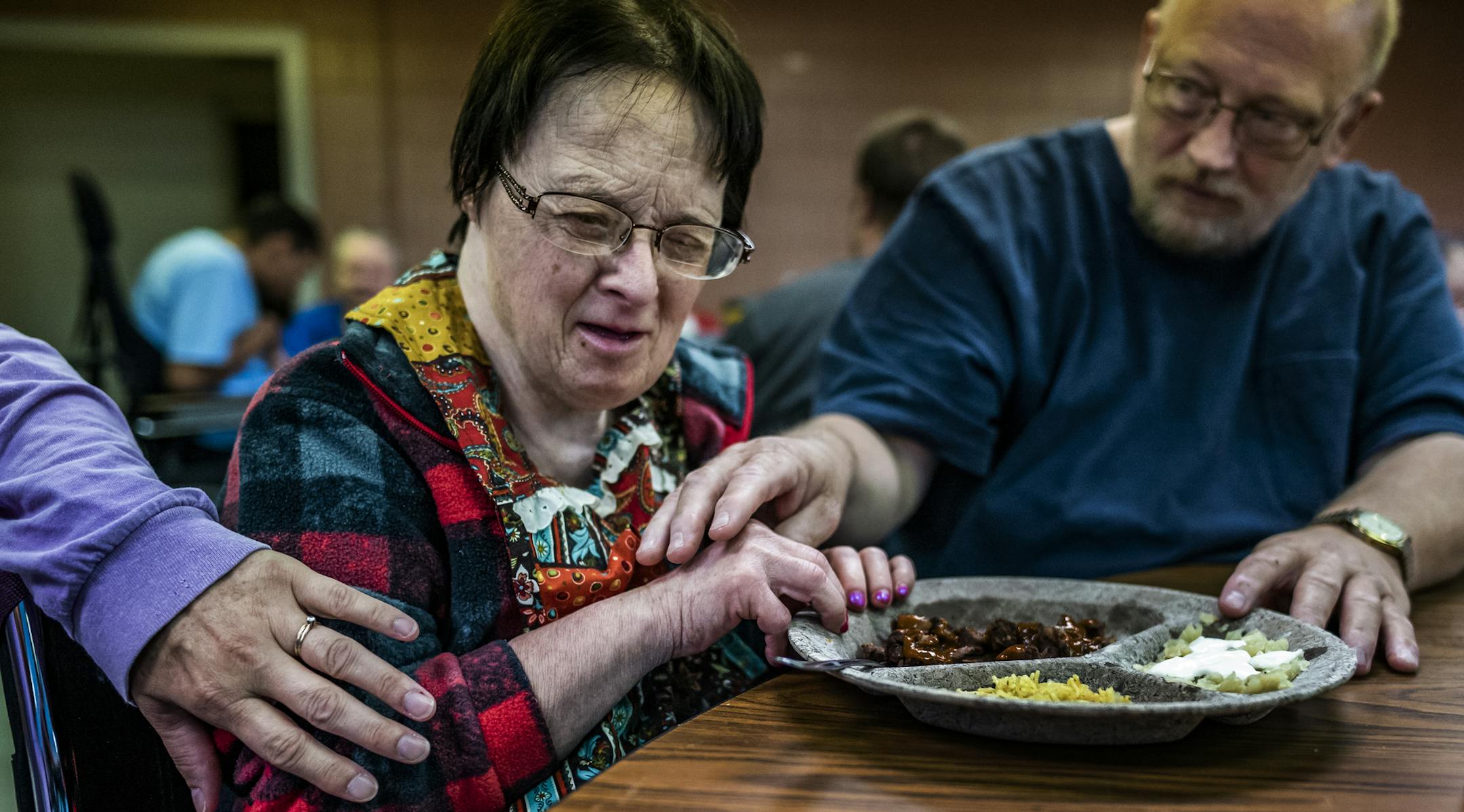 At the Jackson County Developmental Achievement Center, Cathy Joy Schlager, center, loves spending time with friends and staffers like Tim Golda during the day. Isolation in Group Homes. Story on how the state fails to provide adequate oversight of group homes. RICHARD TSONG-TAATARII ¥ richard.tsong-taatarii@startribune.com