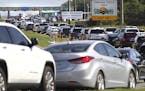 In a Saturday, June 10, 2017 photo, southbound motor vehicles heading for Destin and south Walton County, Florida are backed up at the Mid-Bay Bridge 