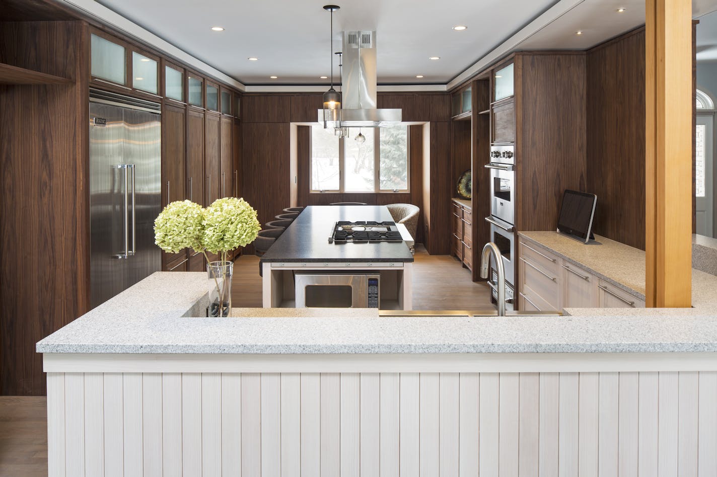 Contrasting light and dark granite counters, whitewashed fir and walnut cabinets are repeated throughout the new spaces.