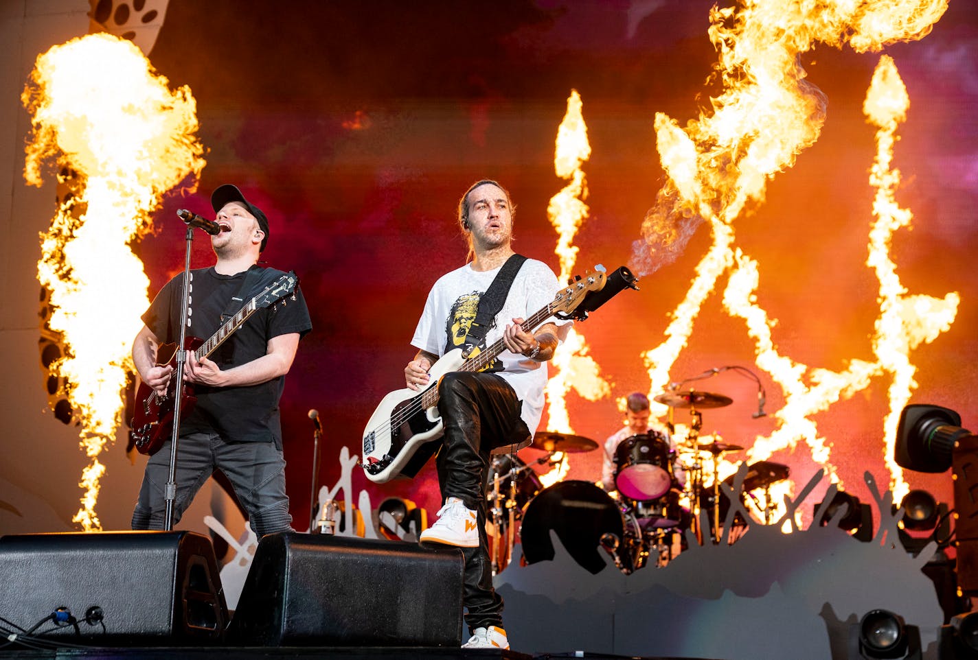 Pete Wentz, bassist for Fall Out Boy, shot flames out of his bass during the band's opening song at the Hella Mega Tour at Target Field in Minneapolis on Monday. ]