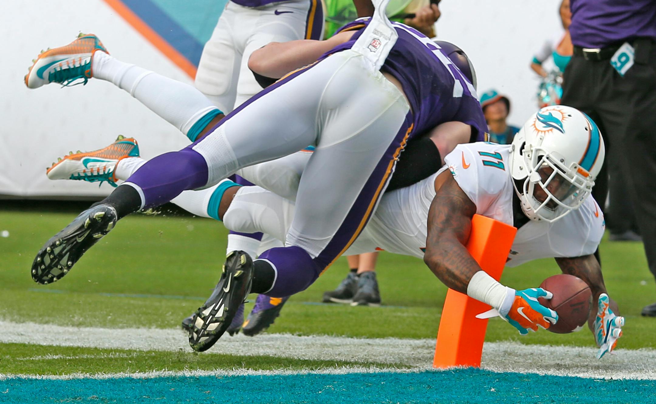 Miami Dolphins' Mike Wallace wraps around an endzone pylon with the ball to score a third quarter touchdown as Minnesota Vikings' Harrison Smith fails to defend on Sunday, Dec. 21, 2014, at Sun Life Stadium in Miami Gardens, Fla. (Charles Trainor Jr./Miami Herald/TNS) ORG XMIT: 1161695