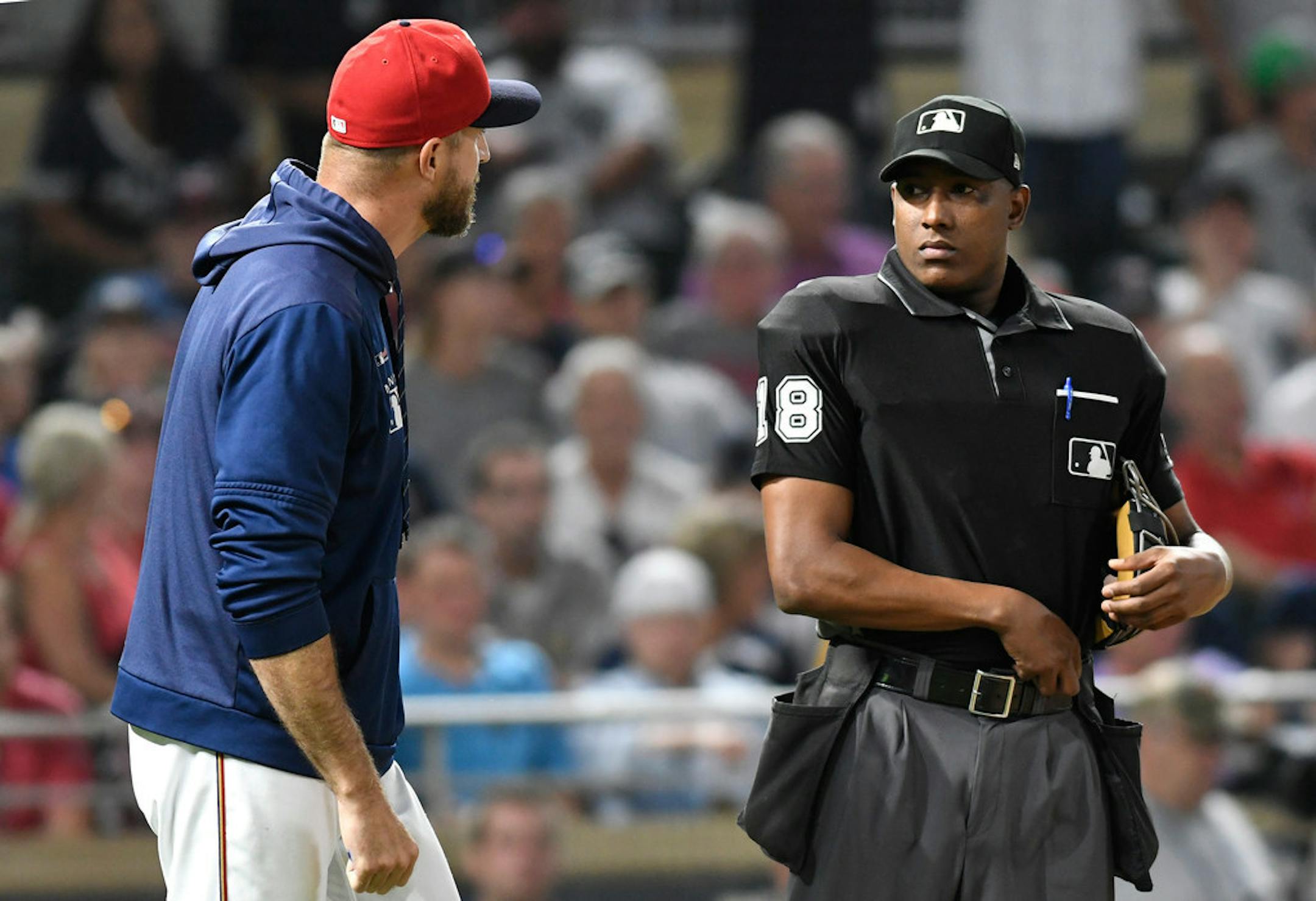 Home plate umpire Ramon DeJesus, right, ejects Minnesota Twins manager Rocco Baldelli, left, after Baldelli complained about balls and strikes in the eighth inning